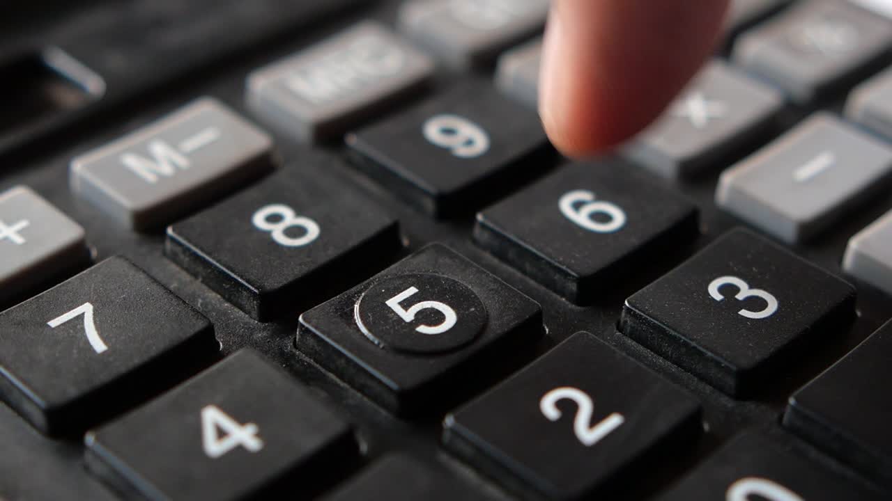 Close up of man hand using calculator