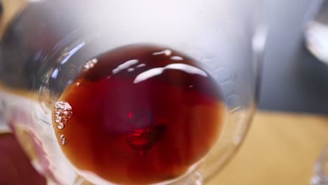 close-up of red wine swirling in glass