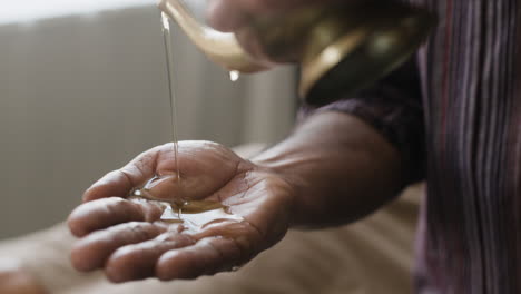 pouring oil into a hand