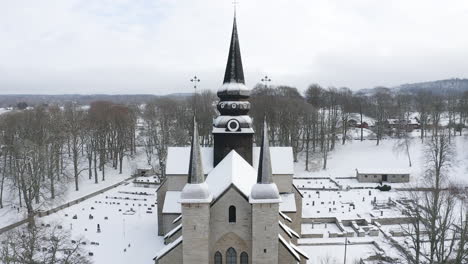 drone shot of a big swedish church in the middle of the woods