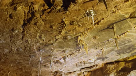 stalactites on rocky cave ceiling