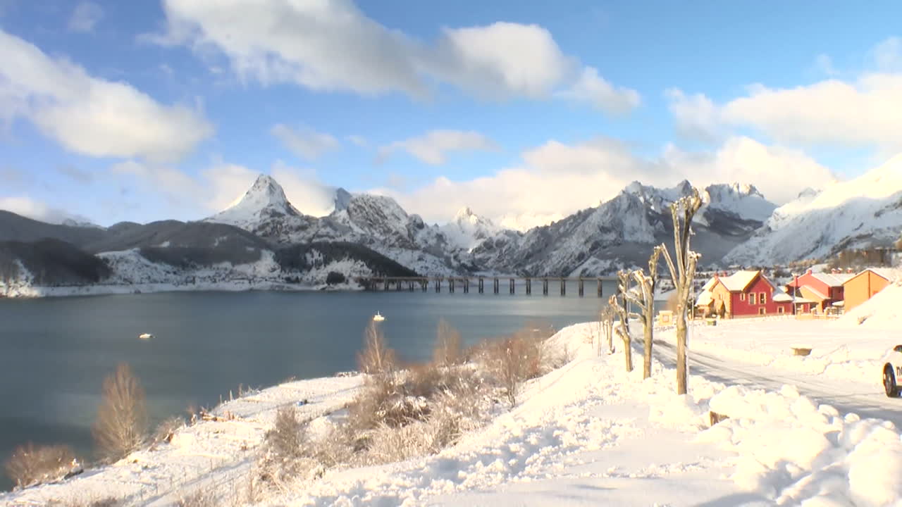 Snowy Mountain Landscape with Lake and Village
