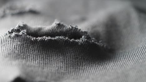 close-up of a ripped gray fabric