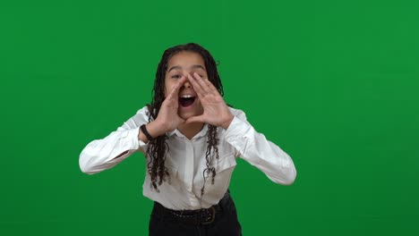 lost african american teenage girl shouting holding hands at mouth on green screen. portrait of disorientated teenager at chromakey background calling for help.