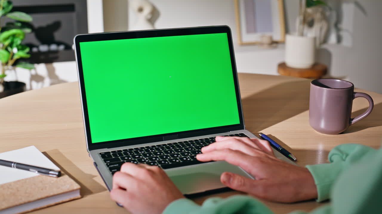 Online manager browsing mockup laptop at modern apartment workspace closeup