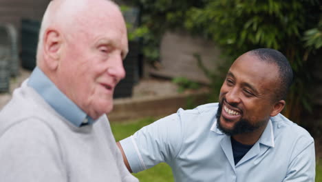 elderly man laughing with caregiver
