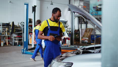mechanic does maintenance on client car