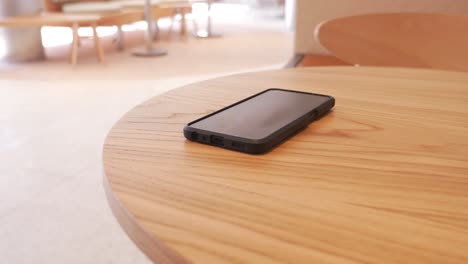 smartphone on a wooden table in a cafe