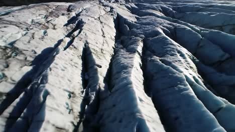 aerial view of a majestic glacier landscape highlighting the dynamic textures and patterns formed by the ice, showcasing nature's power and beauty