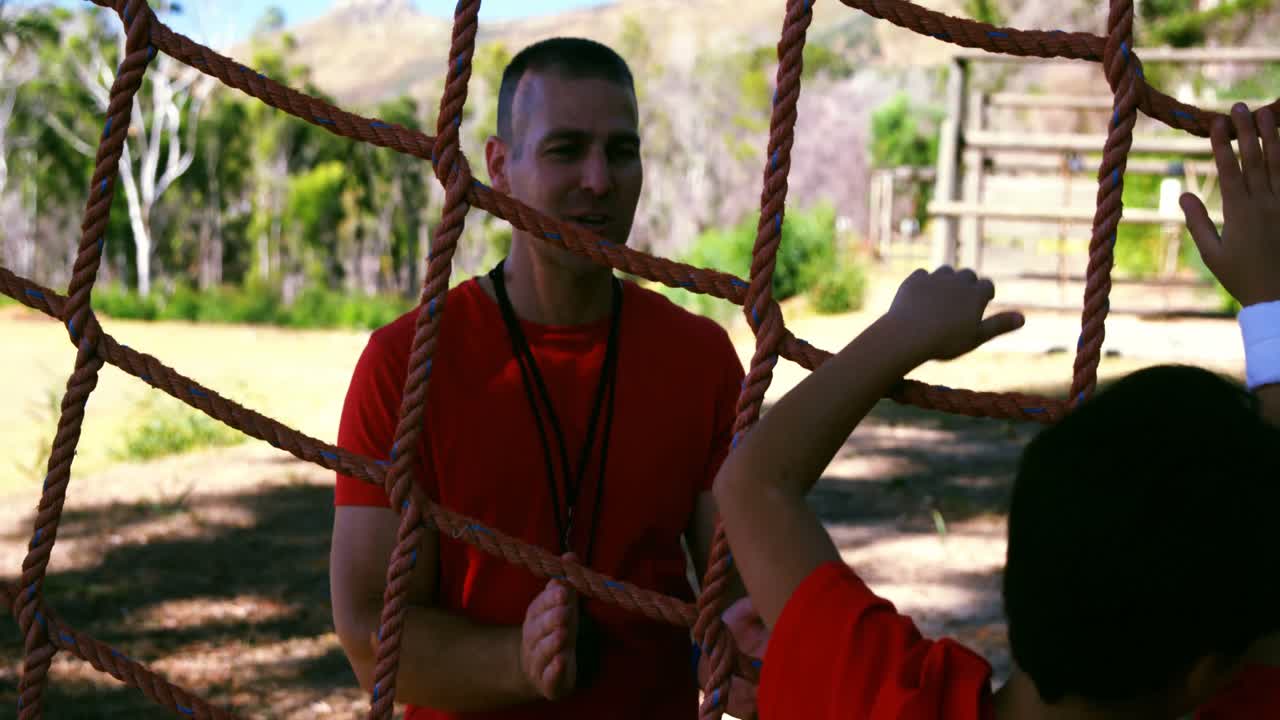 Trainer training kids in the boot camp