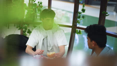 burry view of outdoor swimming pool seen through transparent walls with sunlight sparkling on water surface and reflecting on glass, soft focus creating dreamy bright atmosphere for relaxation