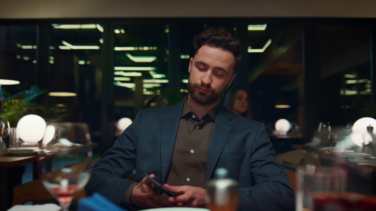 Handsome guy paying restaurant dinner using credit card on evening romantic date