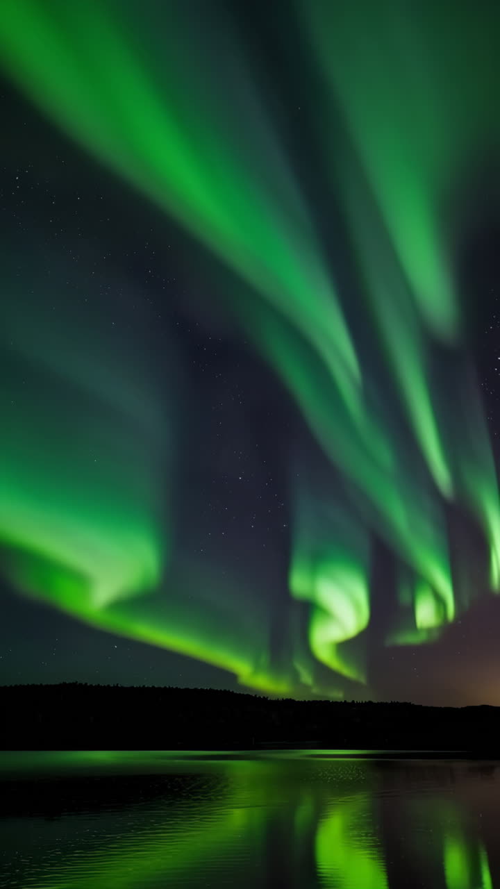 Vibrant Aurora Borealis Reflected in a Calm Lake at Night