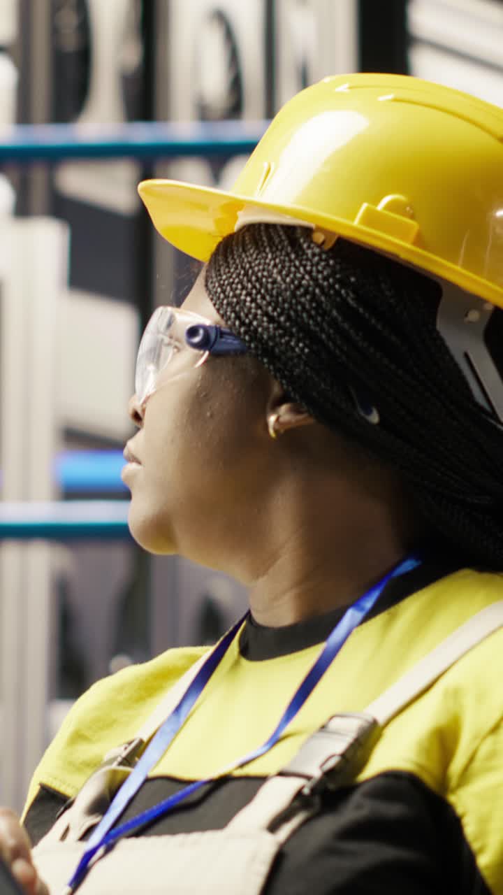 Vertical video Smart factory engineer using tablet to analyze IoT sensors data