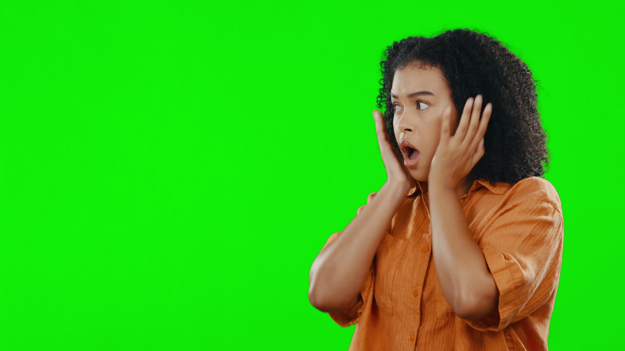 Woman expressing surprise on a green screen