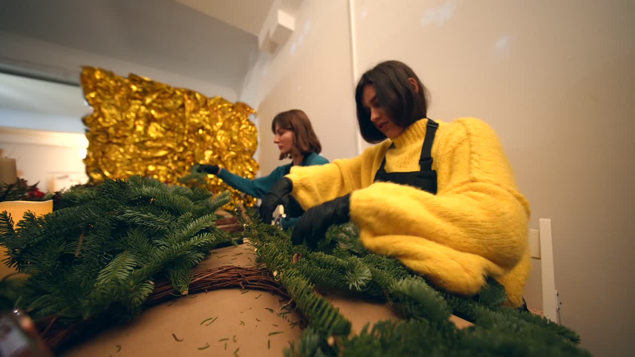 Women making Christmas wreaths at a workshop