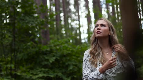 beautiful young women in awe at the beauty surrounding her in a pine forest in the countryside of canada