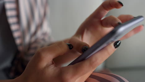 Gadget-user-holding-smartphone-in-hands-closeup.-Girl-checking-social-media