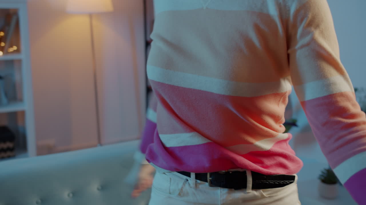 Woman dancing in a living room at night