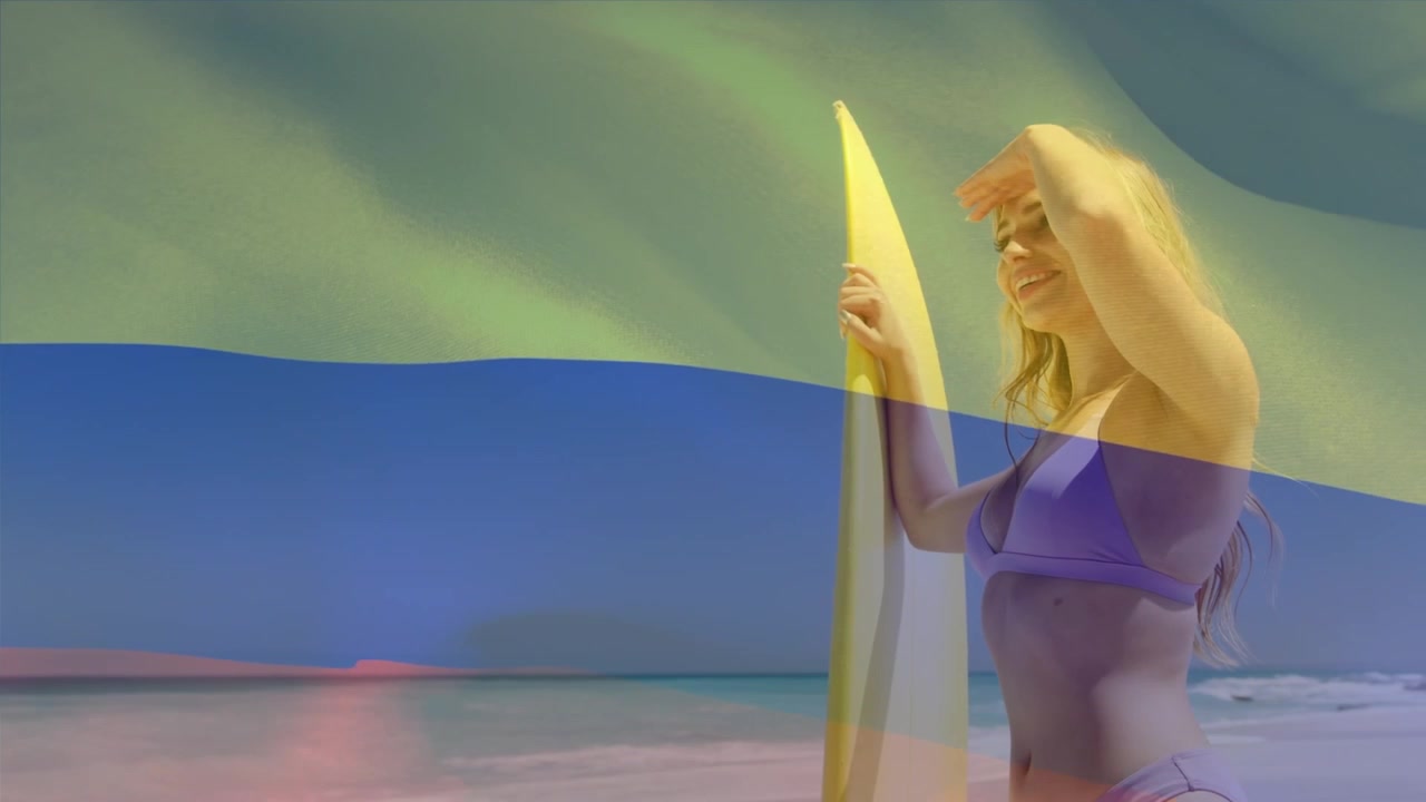 Animation du drapeau de la Colombie sur une femme caucasienne heureuse avec une planche de surf sur la plage.