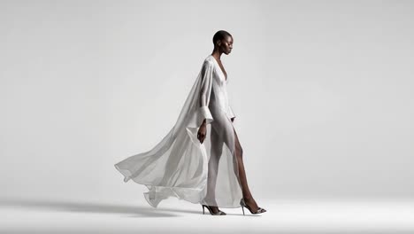 a graceful model flaunting a stunning flowing gown that captures movement and style in a minimalistic studio setting, highlighting elegance and fashion forward thinking
