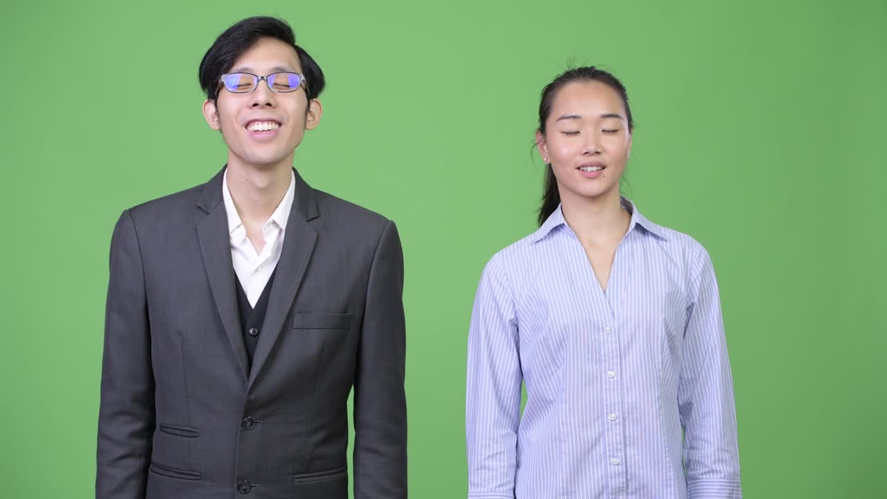 Young Asian business couple relaxing together