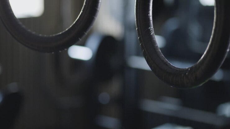 Static view of rings in motion, gymnasium in the background