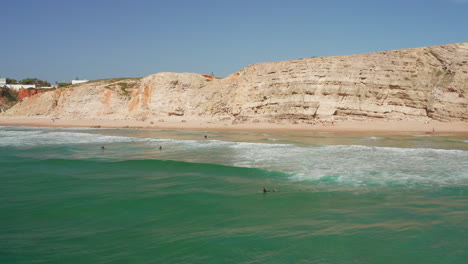 aerial: surfers at sagres during a sunny day