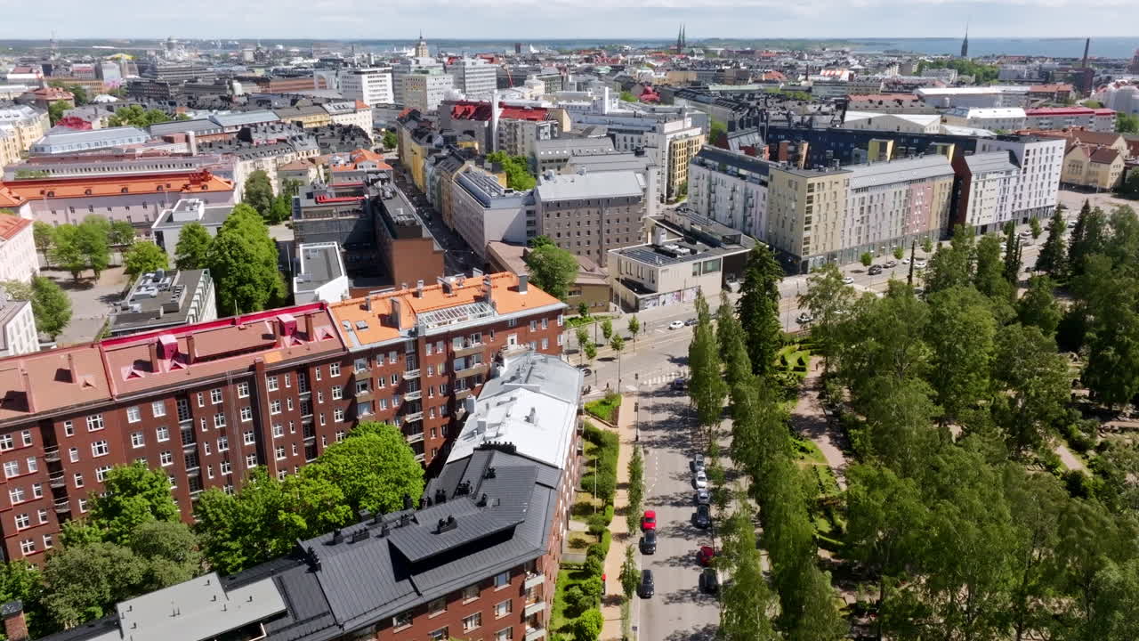 Aerial tilt shot over the Hietaniemenkatu street, revealing the skyline of Helsinki