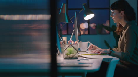 young business woman using computer working late alone successful entrepreneur busy on company project dedicated female in start up office workspace