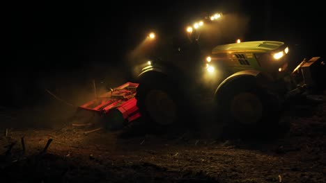 forest mulcher processes tree remains after bark beetle infestation at night