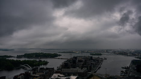 Time-lapse-of-dark-rain-clouds-rolling-over-the-Helsinki-cityscape,-moody-evening