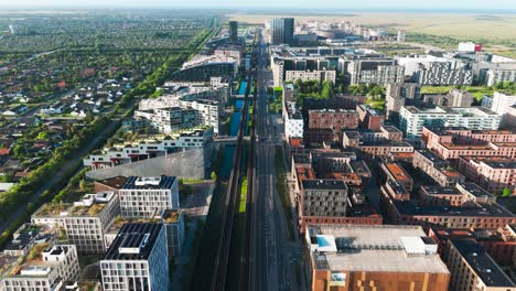 aerial view of orestad main metro line through city neighborhood, denmark