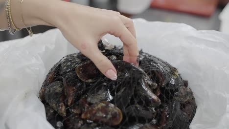 opening up a bag of fresh mussels for cooking