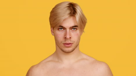 man with towel, yellow background