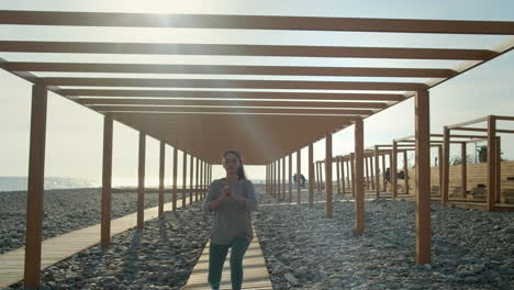 woman practicing yoga on a beach walkway