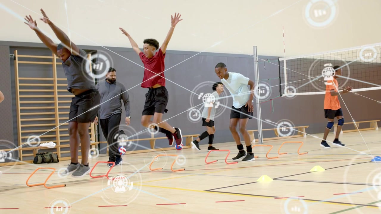 Coach gesturing, players repeating explosive hurdle jumps in gym for agility, HUD tracking metrics