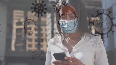 animation of covid 19 icons over woman using smartphone wearing face mask