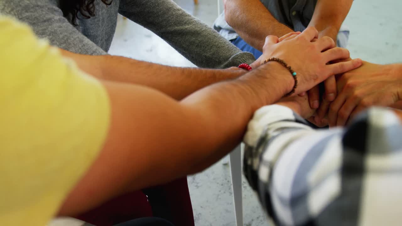 Mid section of people forming hand stack 4k