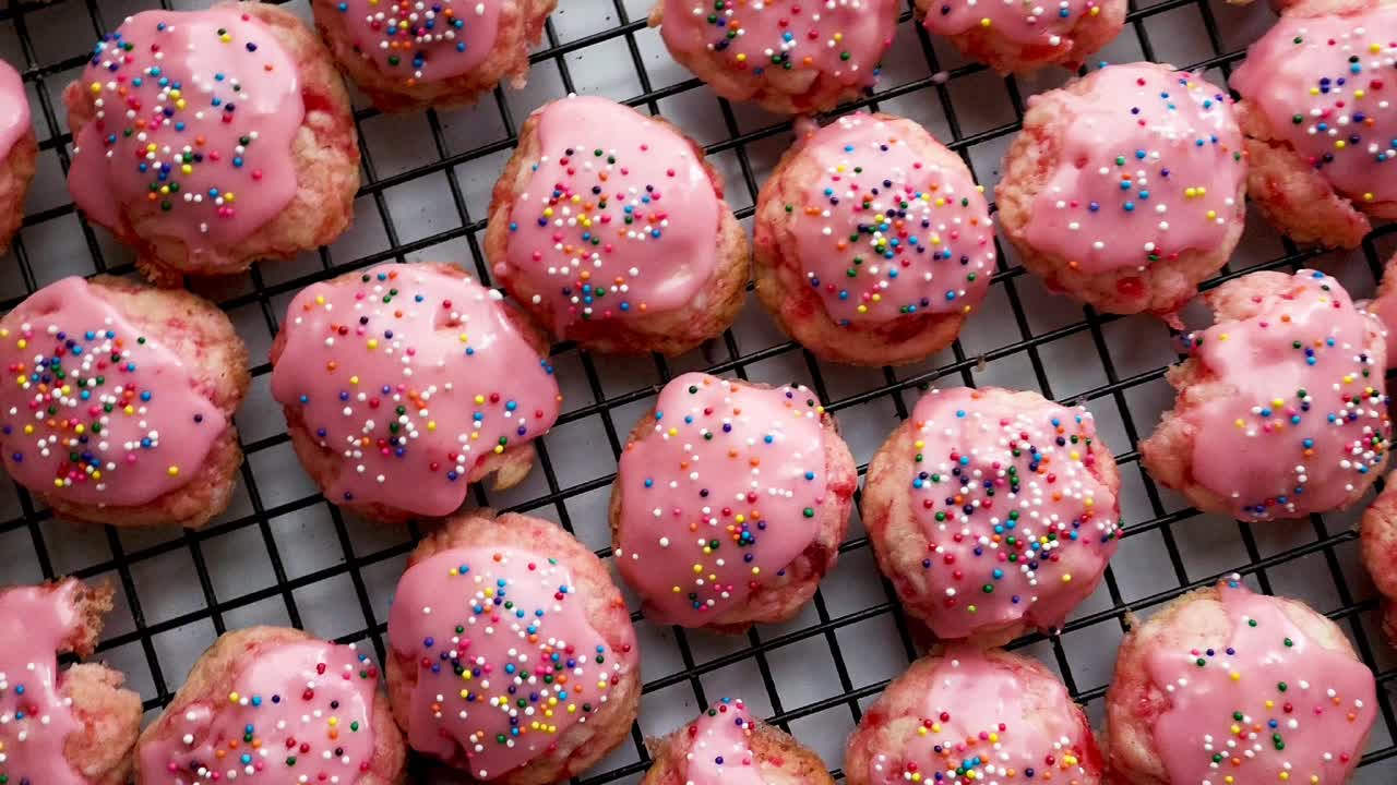 Petits biscuits au cordial de cerise délicieusement recouverts d'un glaçage à la cerise et de vermicelles arc-en-ciel pour les fêtes