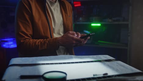 person using a smartphone in a film editing room