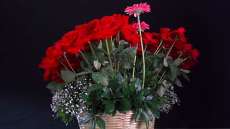 red roses and lily basket spinning with lotus and gerbera decoration black background