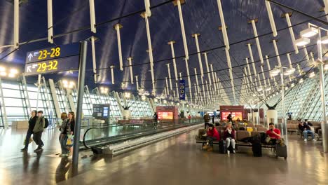 passengers moving through a modern airport terminal