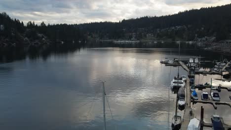 Flying-over-boats-docked-in-a-lake-in-Vancouver,-British-Columbia