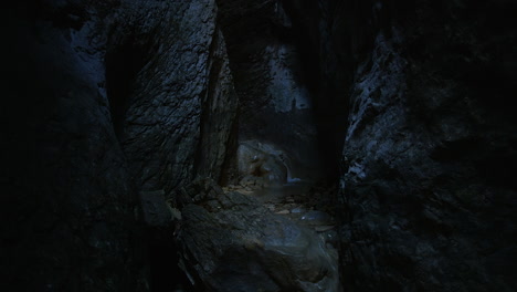 streaming crystal clear water deep inside a narrow canyon where hardly any light penetrates