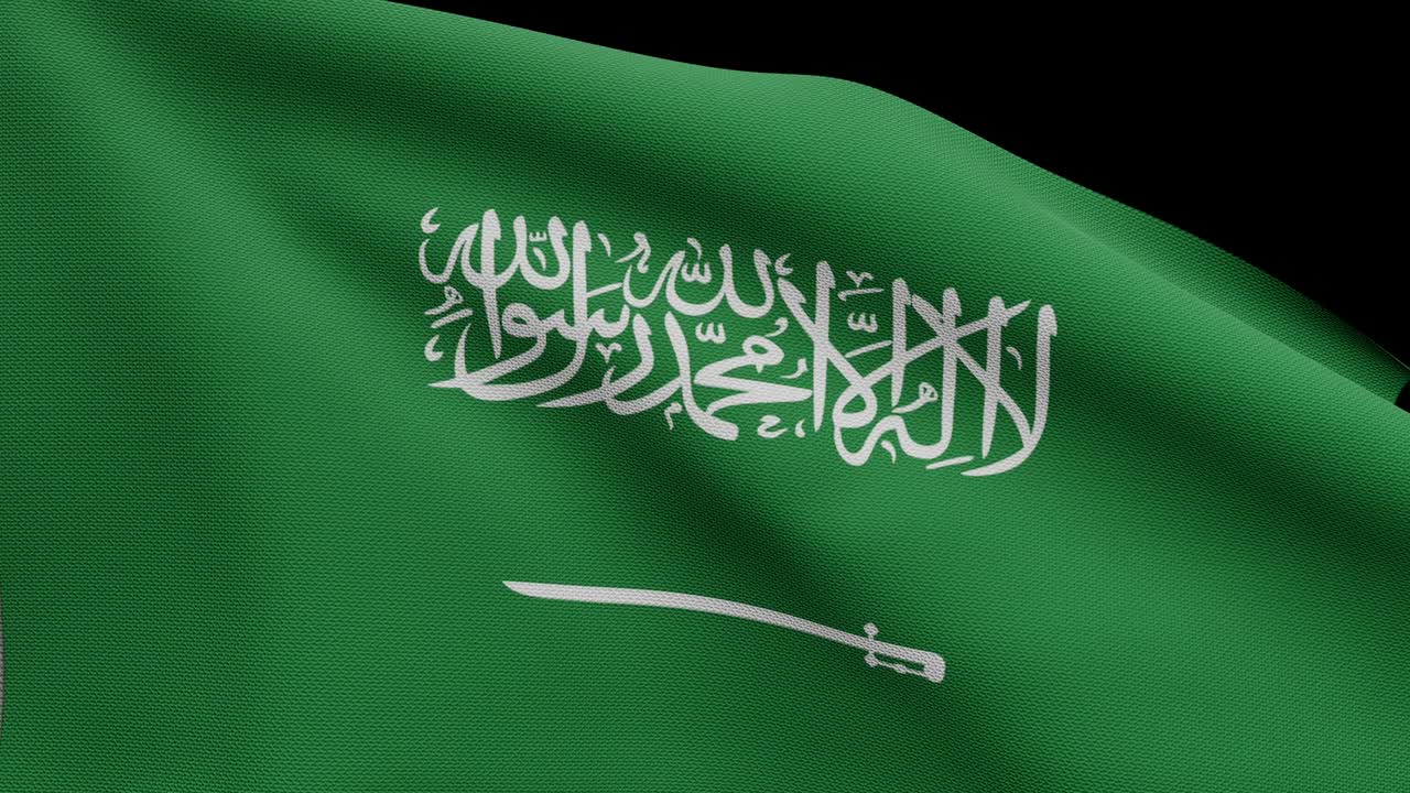 la bandera del reino de arabia saudita ondeando en el viento. un primer plano de la bandera de la ksa soplando