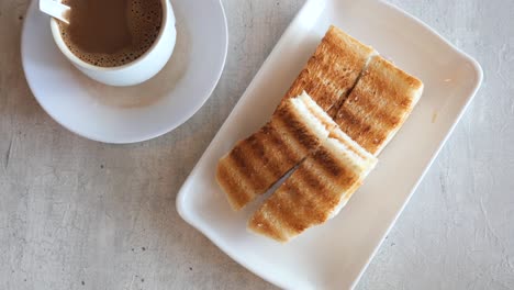 kaya toast with a cup of tea on table ,