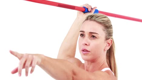 smiling fit woman holding javelin