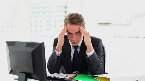 Attractive-businessman-suffering-from-headache-