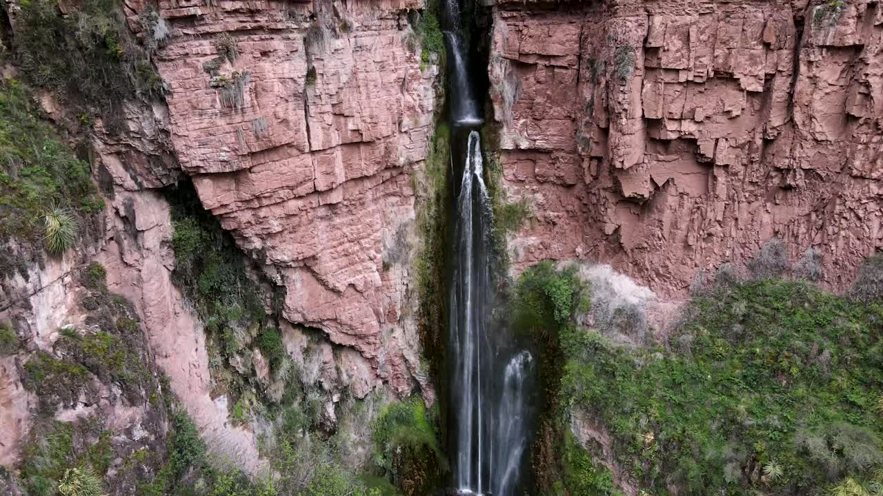 Aerial of the spectacular Perolniyoc Waterfall in Urubamba, Sacred Valley, Cusco, Peru. Drone crane and tilt up